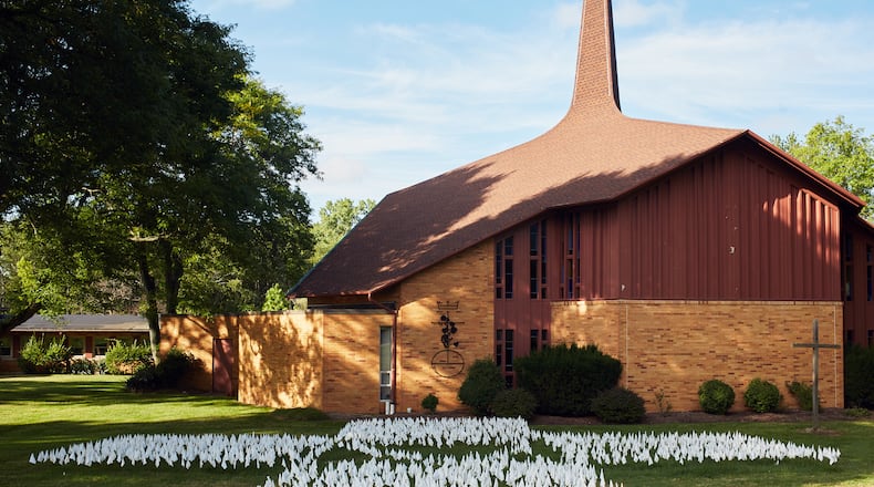FILE -- A memorial of flags honoring Ohioans who have died from COVID-19 at the Church of the Redeemer United Church of Christ in Westlake, Ohio, on Sept. 11, 2020. The death toll in the United States from the coronavirus pandemic passed 200,000 on Tuesday, Sept. 22, 2020 as the first day of fall brings questions about what may be ahead.  (Da'Shaunaue Marisa/The New York Times)