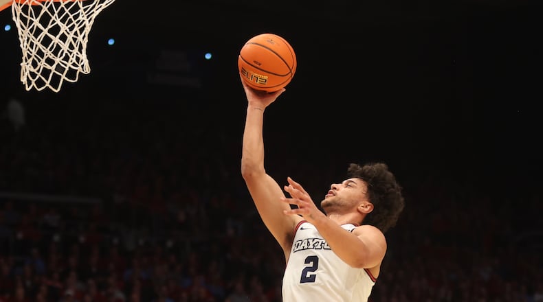 Dayton's Nate Santos scores against George Washington on Tuesday, Jan. 30, 2024, at UD Arena. David Jablonski/Staff