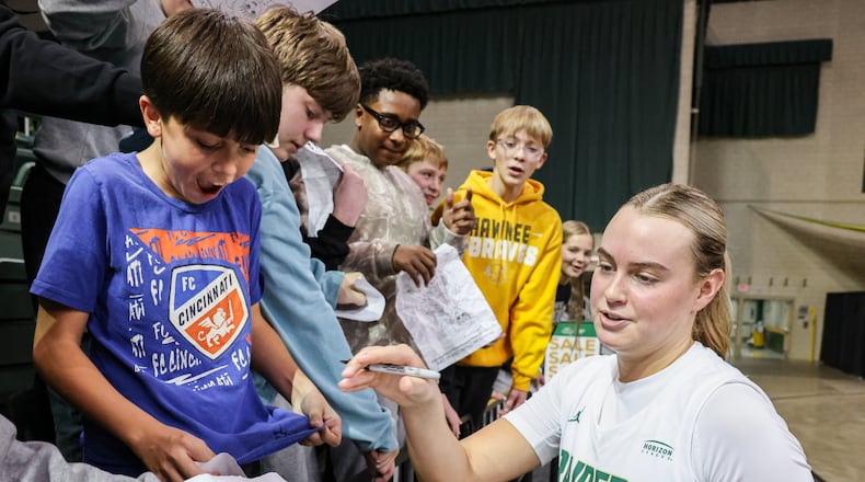Wright State senior guard Claire Henson signs autographs for Springfield Shawnee Middle Schools students as Phillip Reveal (left) reacts after Henson signed his shirt following a game against Bellarmine on Wednesday, Nov. 19 at the Nutter Center in Fairborn. Over 30 schools attended the program's annual Education Day game. The attendance was over 6,000. BRYANT BILLING/STAFF