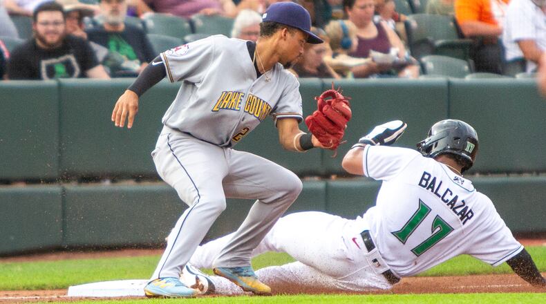 Dayton's Leo Balcazar slides safely into third base during Thursday night's game against Lake County at Day Air Ballpark. Jeff Gilbert/CONTRIBUTED
