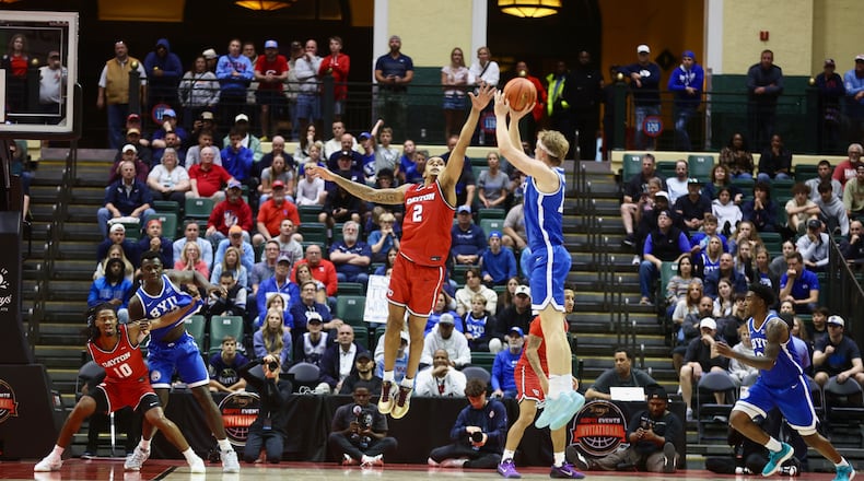 Brigham Young's Richie Saunders makes a 3-pointer as he's fouled by Dayton's De'Shayne Montgomery in the final minutes of the ESPN Events Invitational championship game on Friday, Nov. 28, 2025, at the State Farm Field House in Kissimmee, Fla. David Jablonski/Staff