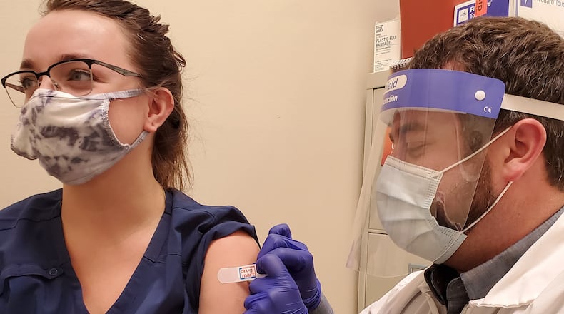 Chris Bowman, chief pharmacist at Discount Drug Mart in Enon, administers a vaccine. The pharmacy chain reports an increase in people requesting flu shots compared to this time last year. Pharmacists, primary care providers and workplaces are gearing up for widespread flu vaccination campaigns this season, trying to mitigate concerns about twin surges of flu and COVID-19. CONTRIBUTED