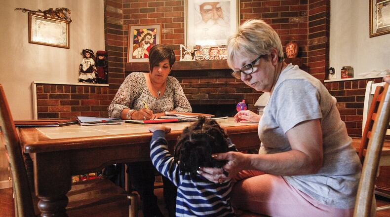 Montgomery County Children Services caseworker Janine Elders visits children in custody currently receiving foster care by Patricia Boring. Elders, with Children Services 22 years, now works with foster parents but spent her first years on the job working directly with families in crisis. She said she was able to cope that long by not taking work home with her. CHRIS STEWART / STAFF