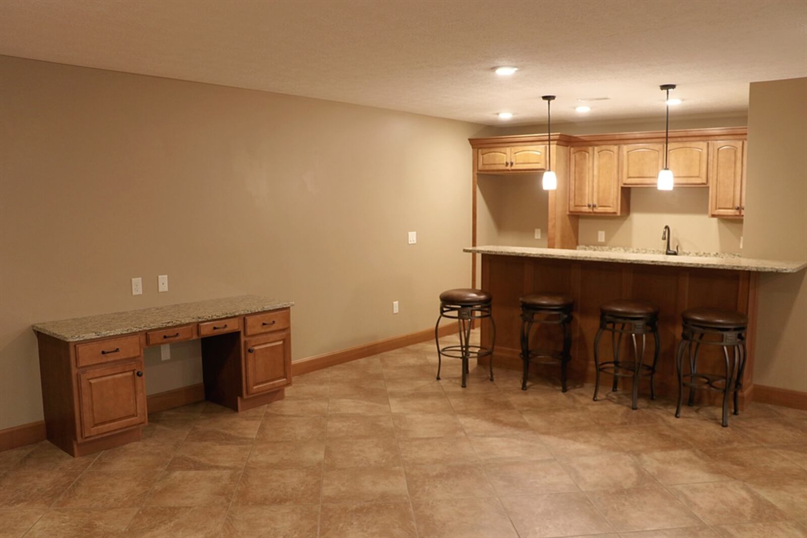 The lower level features a wet-bar area with sink, cabinetry, counter and large appliance nook. 