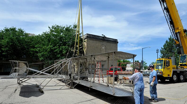 Workers for Schumacher Crane spent Friday moving the Wright Brothers lll sculpture that has been on Monument Avenue across from Riverscape Metro Park for 19 years. The sculpture will be moved to the west end of the Third Street bridge to allow for redevelopment of the Monument Avenue site. MARSHALL GORBY/STAFF