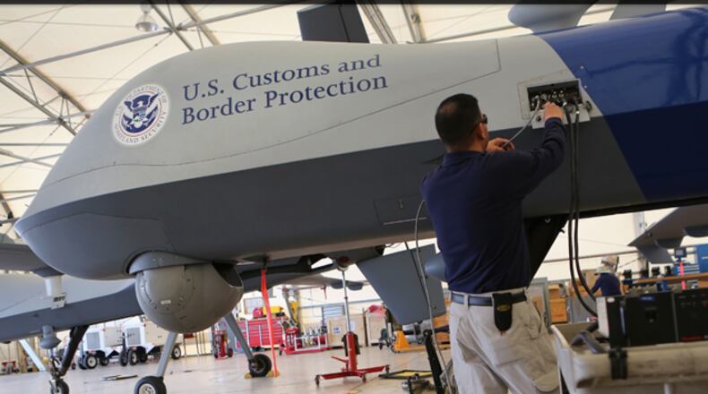 A Predator drone operated by U.S. Office of Air and Marine (OAM), taxis towards the tarmac for a surveillance flight near the Mexican border on March 7, 2013 from Fort Huachuca in Sierra Vista, Arizona. The OAM, which is part of U.S. Customs and Border Protection, flies the unmanned - and unarmed - MQ-9 Predator B aircraft an average of 12 hours per day at around 19,000 feet. The drones, piloted from the ground, search for drug smugglers and immigrants crossing illegally from Mexico into the United States. (Photo by John Moore/Getty Images)