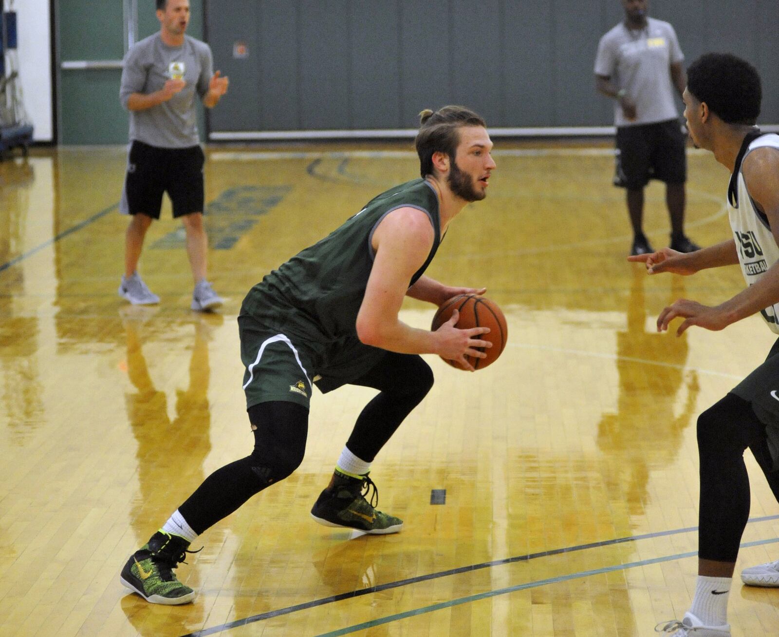 Wright State sophomore Bill Wampler looks for a driving lane against freshman James Manns during summer practice Thursday at the Setzer Pavilion.