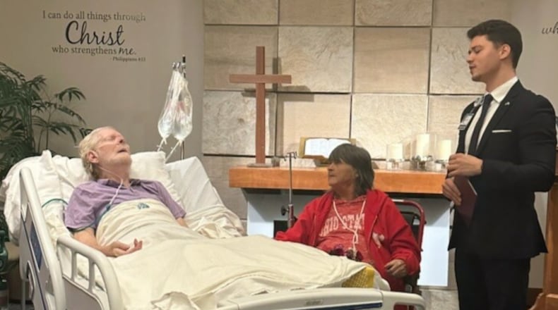 Chaplain Kevin Gill Walter (right) officiating a surprise vow renewal for Dale and Frances Tufts (left and middle) held in the chapel at Kettering Health Main Campus on Oct. 30, 2023. CONTRIBUTED