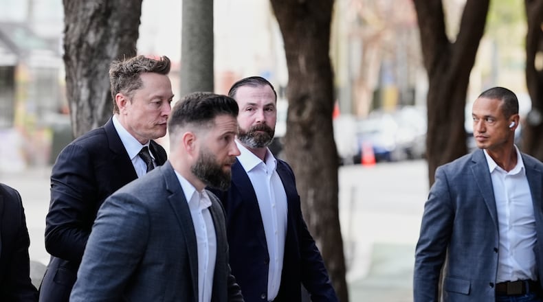 Elon Musk, left, arrives for a Twitter shareholder trial at the U.S. District Court for the Northern District of California, Wednesday, March 4, 2026, in San Francisco. (AP Photo/Godofredo A. Vásquez)