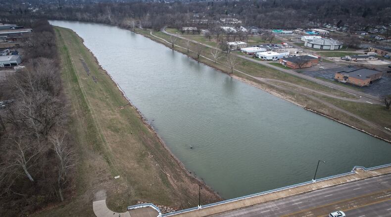 The Miami Conservancy District is planning to build a paved trail on the south/east side of the Great Miami River near Old North Dayton in phases over the coming years. This aerial view shows the river from the Keowee Street bridge looking southwest. The existing Great Miami River Recreational Trail can be seen on the right side of the photo, and the new trail would go on the left. JIM NOELKER/STAFF