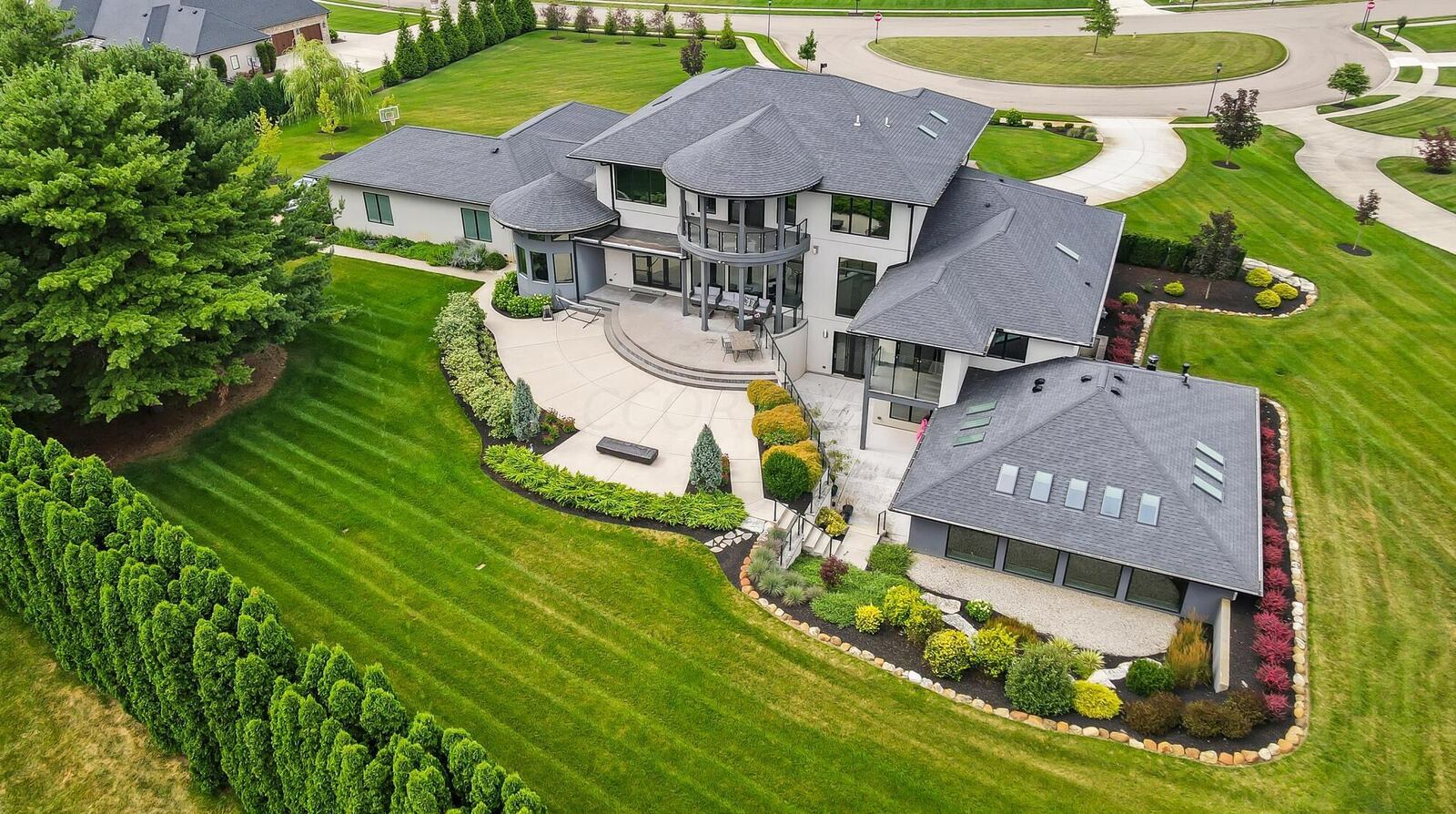 The back yard has multiple patios and levels, an indoor pool and balconies off the second level living room and the main level primary suite. The property also has solar panels.