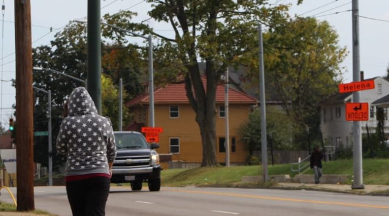 A woman walks along North Main Street, headed toward Helena Street, which is where a woman was shot Wednesday morning. North Main Street is a hotbed of prostitution and other criminal activities, according to neighbors and police. CORNELIUS FROLIK / STAFF