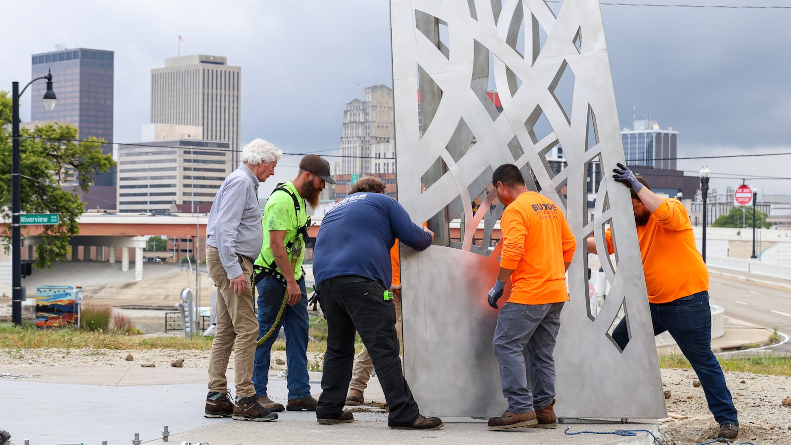 Workers from Budde Sheet Metal Works secure one of the 30-foot spires at the Montgomery County Law Enforcement Memorial beside the Dayton Masonic Center. BRYANT BILLING / STAFF