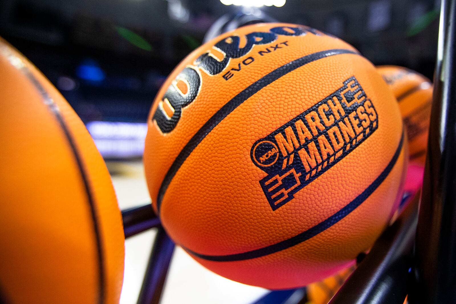 FILE - A basketball with a March Madness logo rests on a rack before a First Four game between Illinois and Mississippi State in the NCAA women's basketball tournament, March 15, 2023, in South Bend, Ind. (AP Photo/Michael Caterina, File)