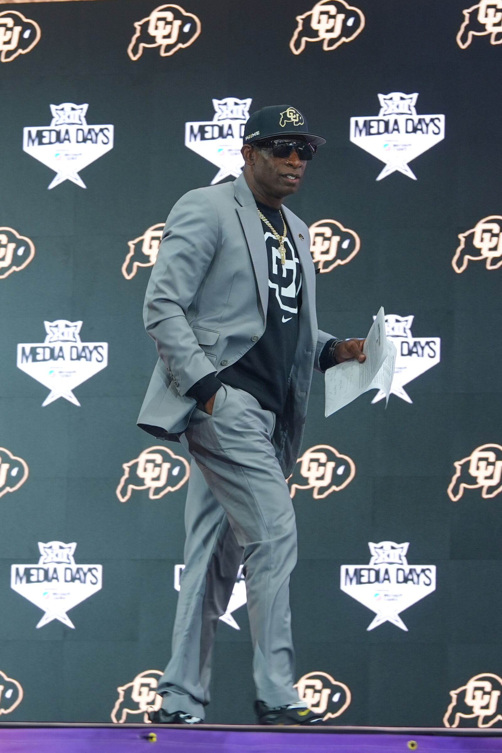 Colorado head coach Deion Sanders walks on stage to speak during the Big 12 NCAA college football media day in Frisco, Texas, Wednesday, July 9, 2025. (AP Photo/LM Otero)
