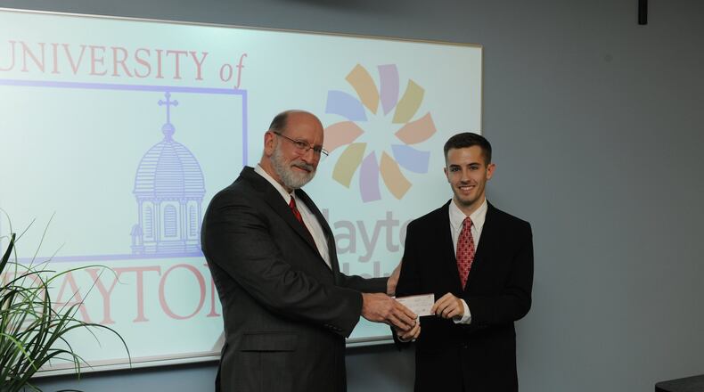 Brandon Mayforth, a UD senior, presents a $500 check to Adam Mezoff, vice president and chief medical officer at Dayton Children’s Hospital. Mezoff discovered Mayforth suffered from a rare disease during his freshman year at UD.