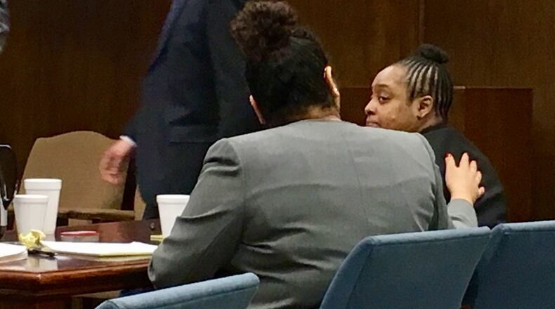 Nina Davis, right, is comforted in Montgomery County Common Pleas Court on Monday, March 20, 2017. Davis is accused of the shooting death of her boyfriend last year in Dayton.