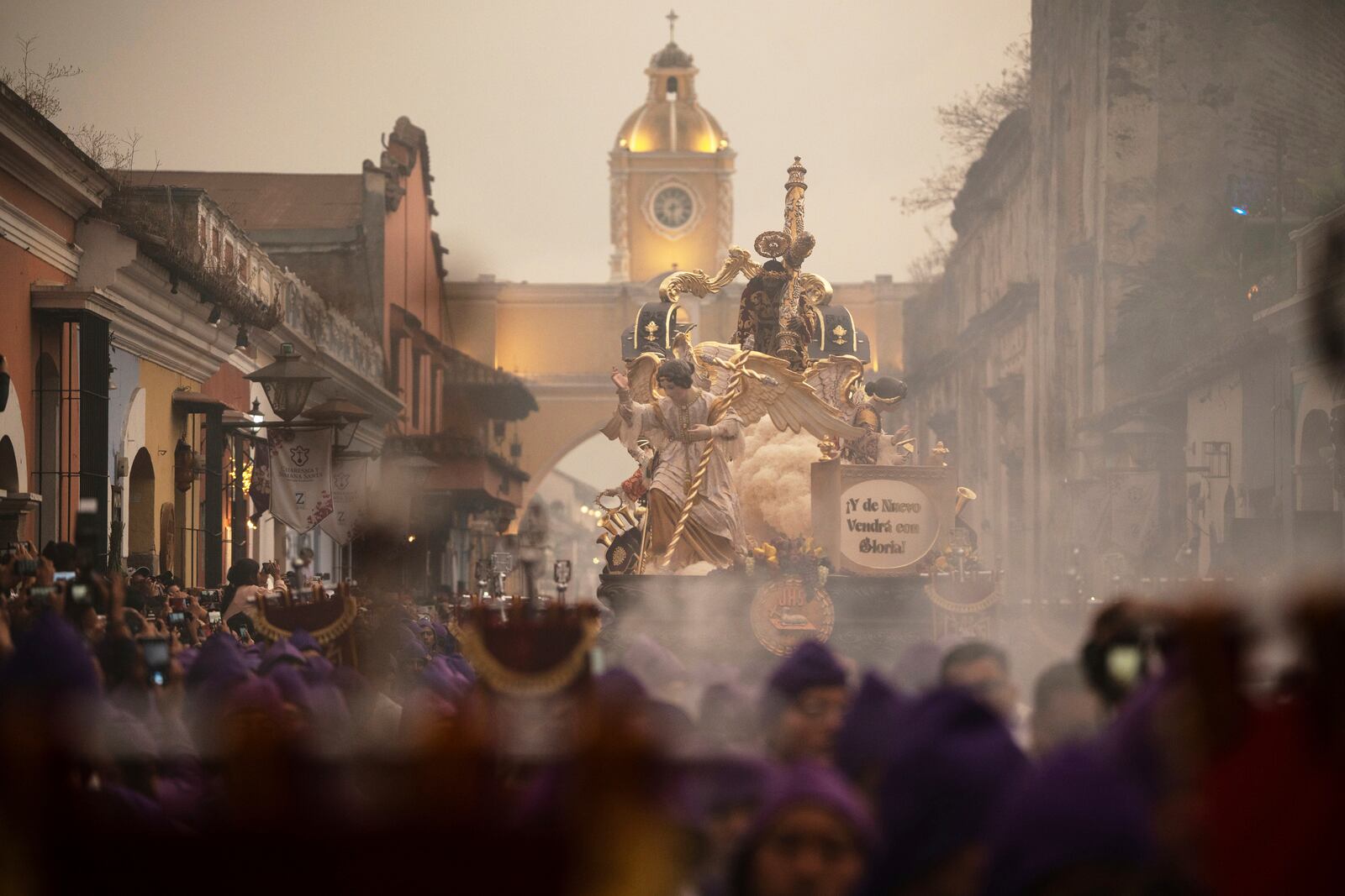Faithful carry a wooden platform with a statue of Jesus of Nazareth, wearing a tunic created by weavers at the Maria Auxiliadora embroidery workshop, during a Lenten season procession in Antigua, Guatemala, Sunday, April 6, 2025. (AP Photo/Santiago Billy)
