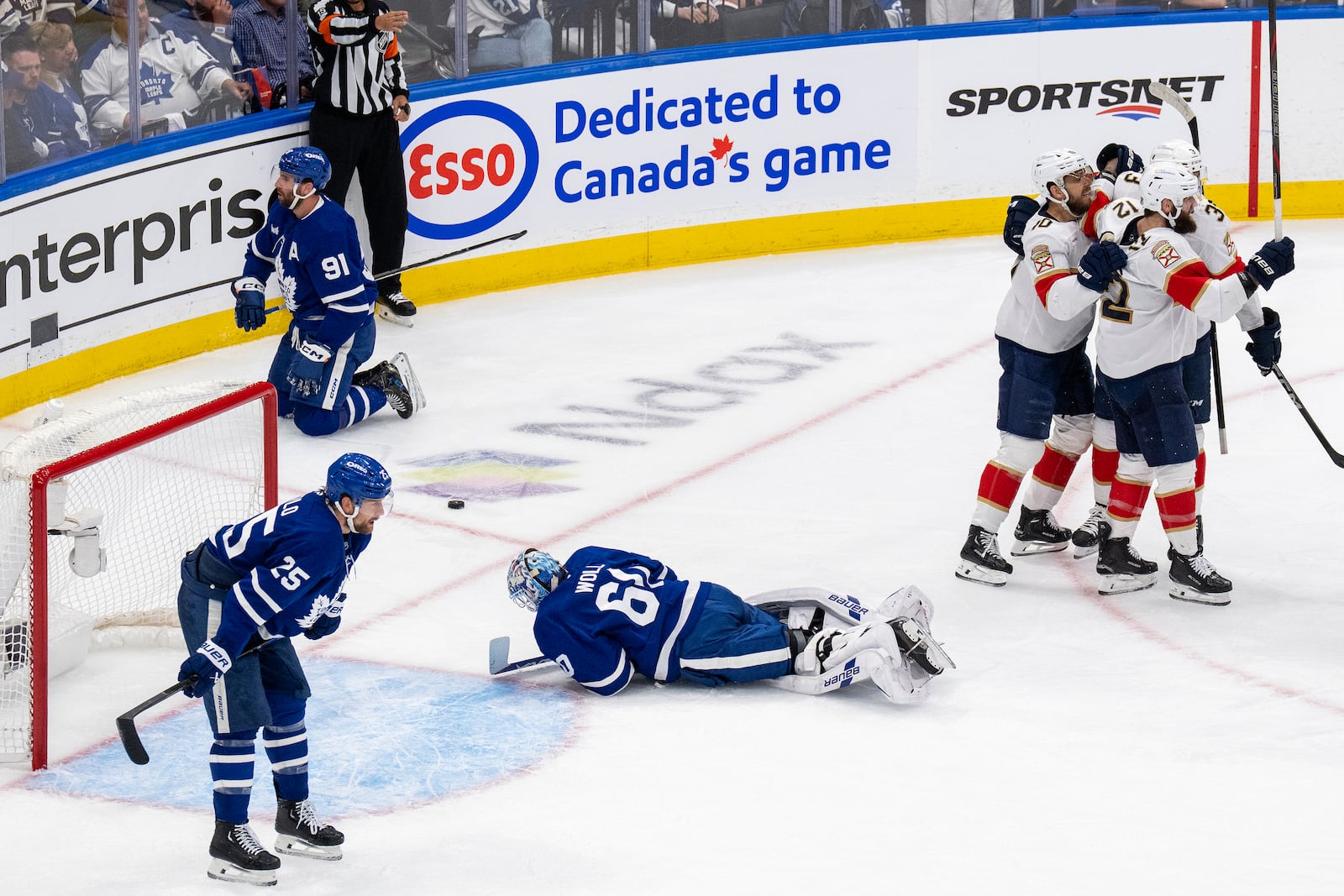 Florida Panthers left wing Jonah Gadjovich (12) celebrates after his goal with teammates as Toronto Maple Leafs goaltender Joseph Woll (60) and others look on during the second period of Game 7 of a second-round NHL hockey playoff series in Toronto, Sunday, May 18, 2025. (Chris Young/The Canadian Press via AP)