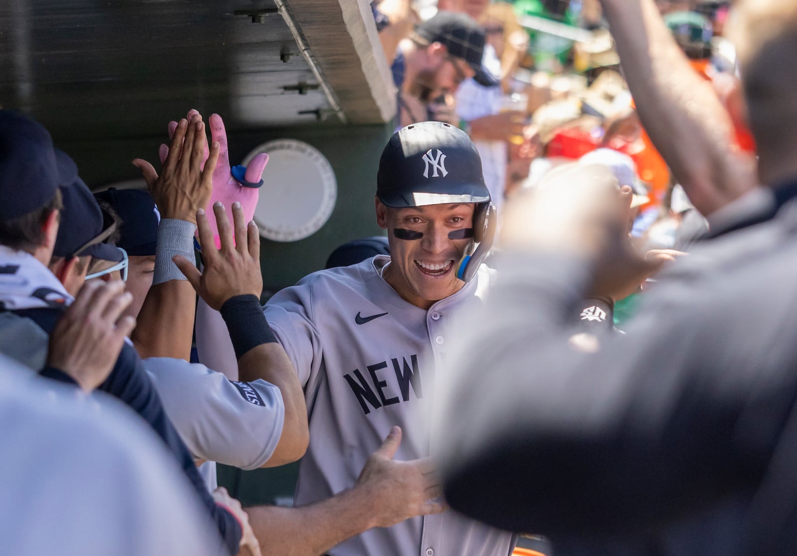 New York Yankees' Aaron Judge, center, celebrates in the dugout after hitting a solo home run during the fourth inning of a baseball game against the Athletics, Saturday, May 10, 2025, in West Sacramento, Calif. (AP Photo/Sara Nevis)