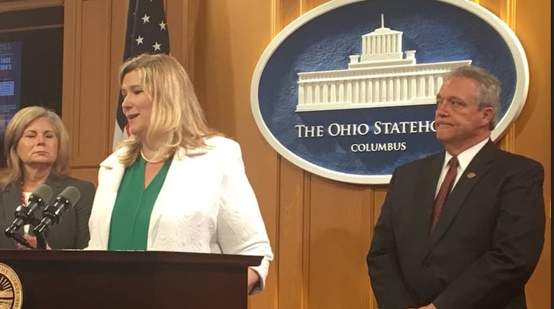 Dayton Mayor Nan Whaley, at podium, speaks at a press conference Thursday in Columbus to introduce legislation to form a cabinet-level office to coordinate drug policy in Ohio. Also pictured are Whitehall Mayor Kim Maggard, to the left of Whaley, and State Rep. Richard Brown, D-Canal Winchester, right. KATIE WEDELL/STAFF