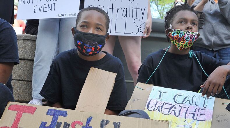 Two young boys take part in a rally for George Floyd Saturday, May 30, in Downtown Dayton. MARSHALL GORBSTAFF
