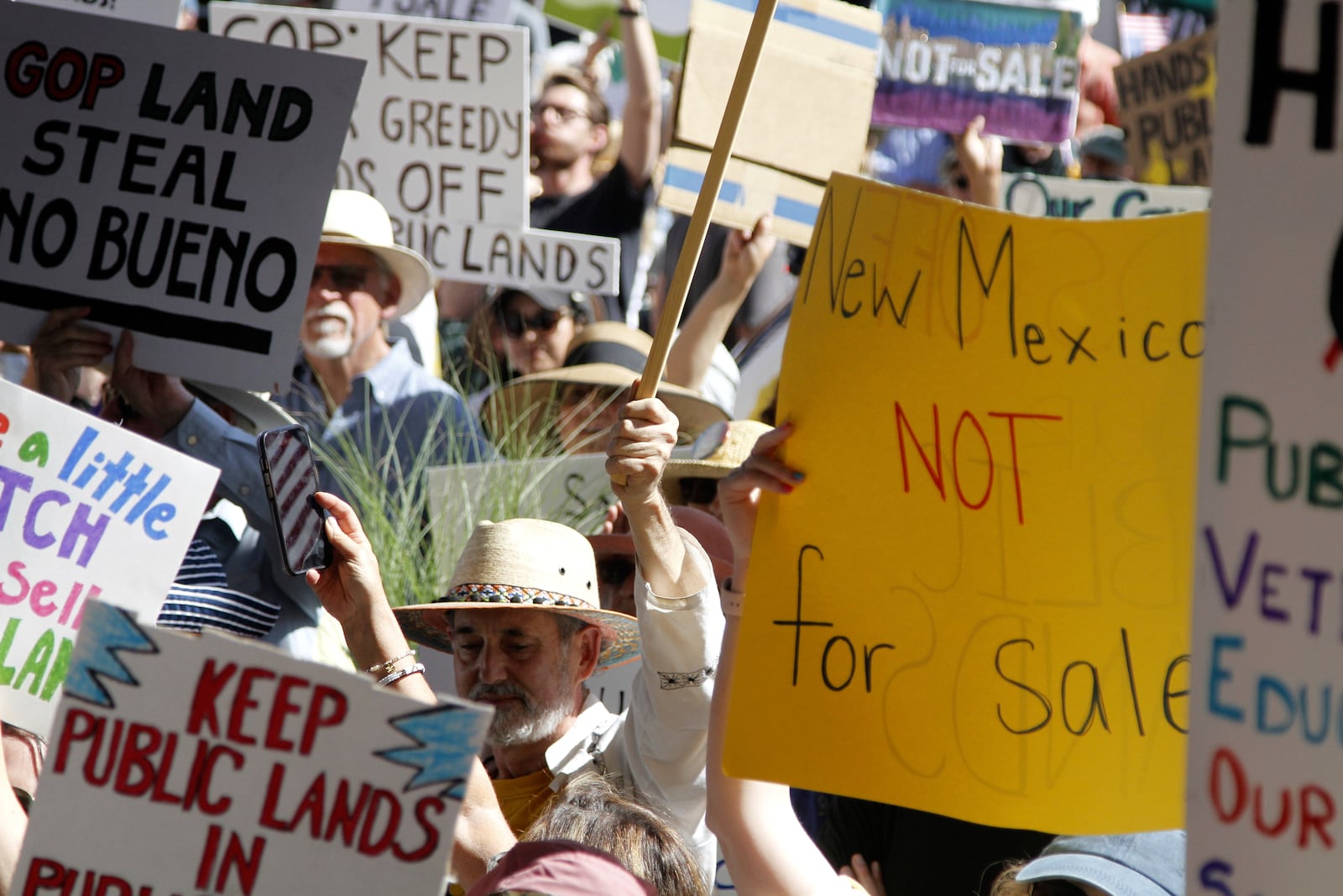 Hundreds of people protest efforts to privatize federal public land in Santa Fe, N.M., outside a meeting of governors from western states and top Trump-administration officials, as Agriculture Secretary Brooke Rollins announced plans to rescind a decades-old rule that blocked logging on national forest lands, in Santa Fe, N.M., Monday, June 23, 2025. (AP Photo/Morgan Lee)