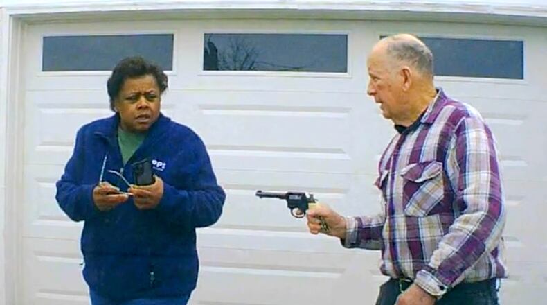 In this image taken from Uber dashcam video released by the Clark County, Ohio, Sheriff's Office, William Brock, right, points a weapon at Uber driver Loletha Hall outside his home in South Charleston, Ohio, on March 25, 2024. Brock, 81, fatally shot Hall. Authorities said Brock thought Hall was trying to rob him after scam phone calls deceived them both. Brock has been indicted on a murder charge. Hall had no knowledge of the calls made to Brock, authorities said. (Clark County Sheriff's Office via AP)