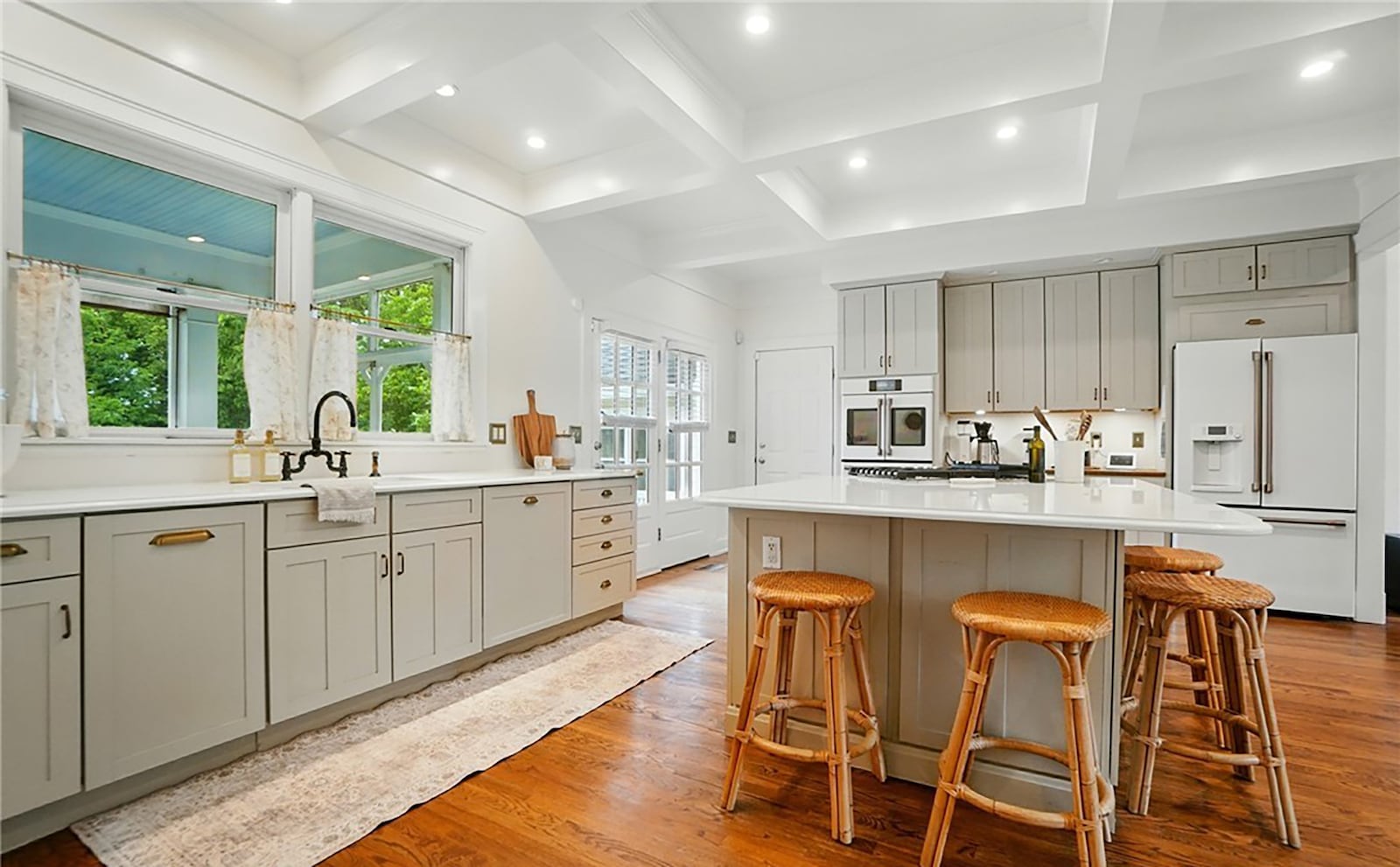 The totally remodeled kitchen has updated appliances, wood floors and a kitchen island with bar seating. CONTRIBUTED