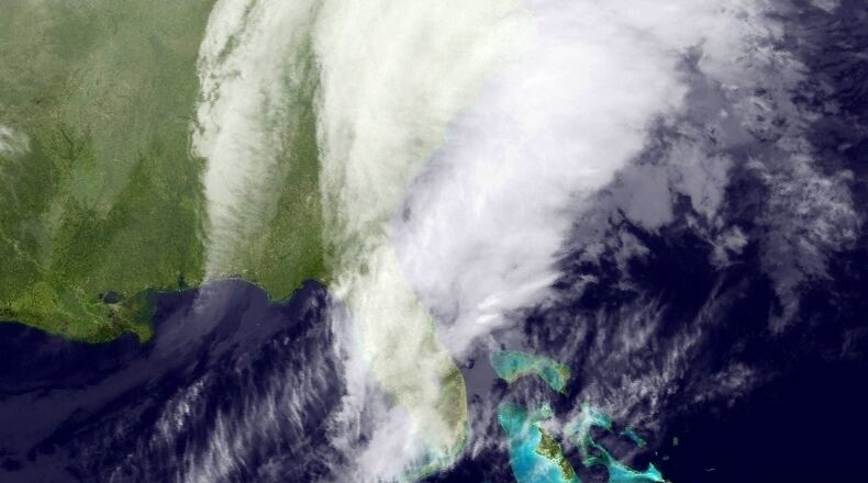 This satellite image taken around 12:12 a.m. EDT and released by the National Oceanic and Atmospheric Administration, shows clouds around the Northeast of the United States, Tuesday, March 14, 2017. A powerful nor'easter could bring blizzard conditions and more than a foot of snow from the mid-Atlantic to parts of the Northeast, and officials warn of potential beach erosion, possible coastal flooding and power outages from the late-season snowstorm. (NOAA via AP)