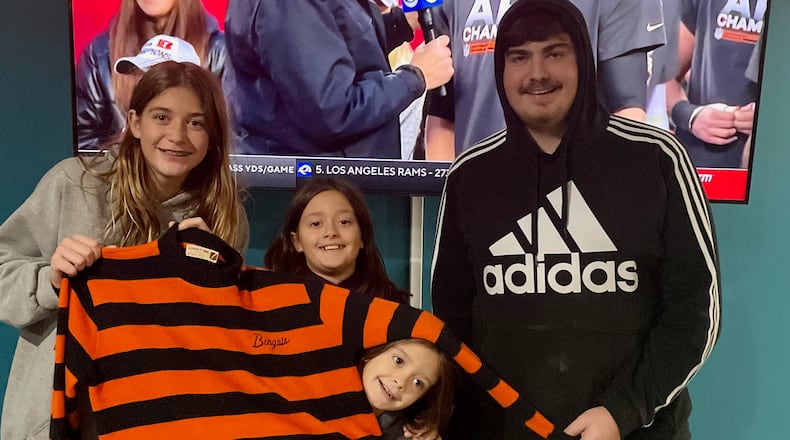 Mike Leo's grandkids hold his Bengals sweater after the Bengals beat the Chiefs on Sunday in the AFC Championship game. Pictured are: Madison Leo, 14; Joslyn Leo, 10; Kensington Leo, 8; and Austin Leo, 16. Photo courtesy of Scott Leo