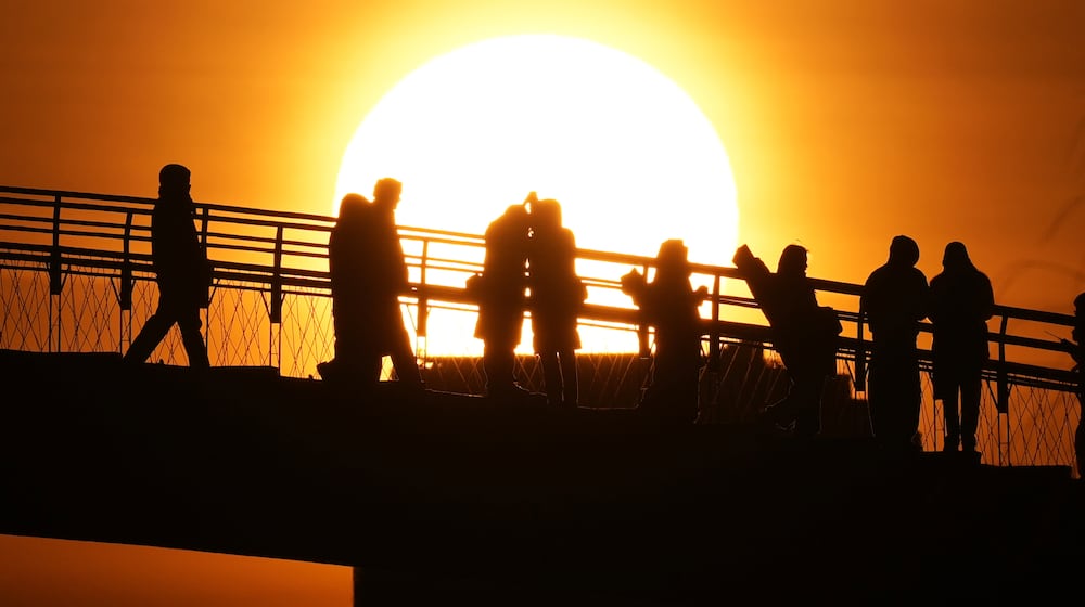 People watch the sunrise on New Year's Day in Seoul, South Korea, Thursday, Jan. 1, 2026. (AP Photo/Lee Jin-man)