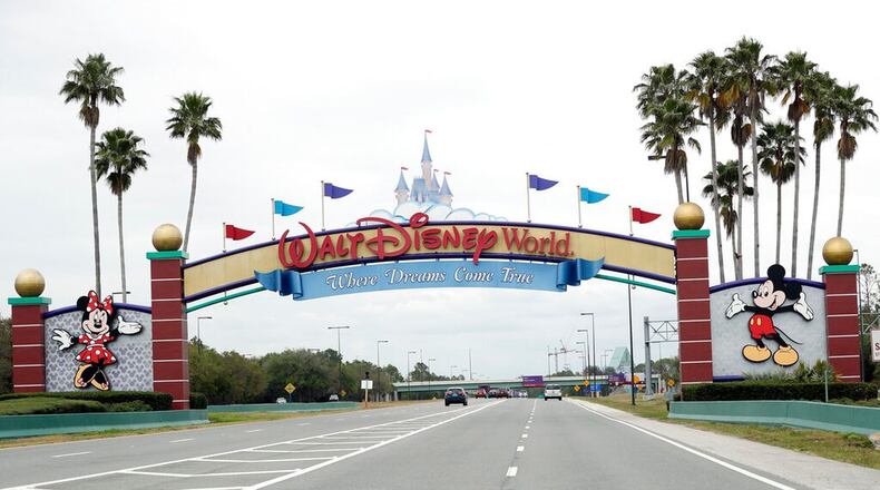 FILE - In this Monday, March 16, 2020, file photo, the road to the entrance of Walt Disney World has few cars, in Lake Buena Vista, Fla. Two more unions have reached agreements with Walt Disney World over furloughs caused by the theme park resort's closure during the new coronavirus outbreak. The agreements reached late Friday, April 10, apply to security guards and workers involved in facilities and operations. (AP Photo/John Raoux, File) (John Raoux/AP)