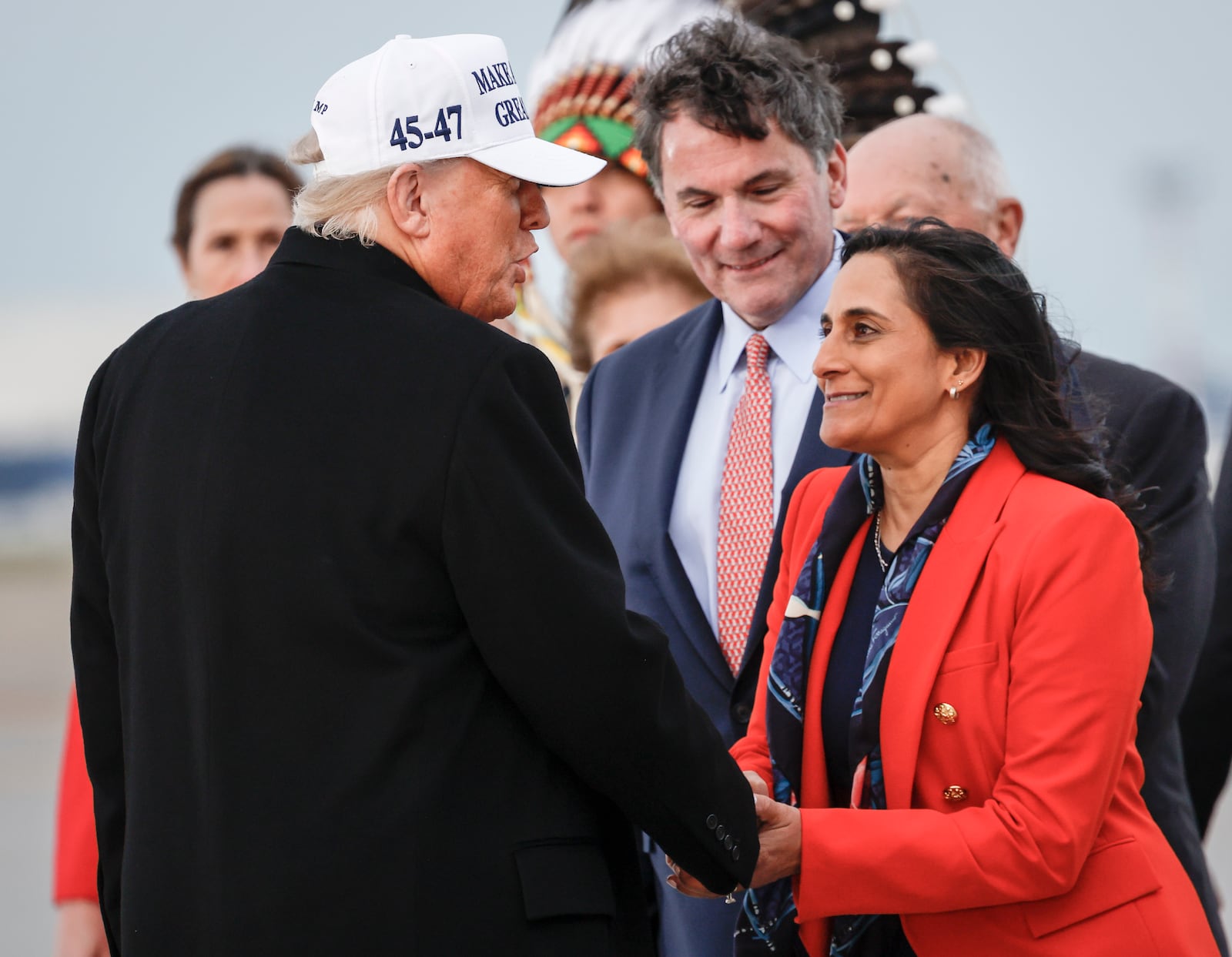 President Donald Trump, left, is greeted by Foreign Affairs Minister Anita Anand, right, and Dominic LeBlanc, center, Minister of Intergovernmental Affairs, as he arrives in Calgary, Alberta, Sunday, June 15, 2025, to attend the G7 Leaders meeting taking place in Kananaskis, Alberta. (Jeff McIntosh/The Canadian Press via AP)