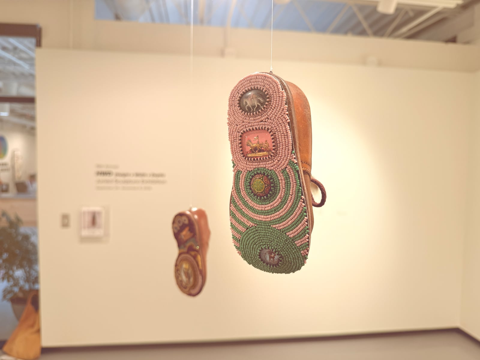 Jennifer Whitten, "Footing", 2023, beadwork assemblage. Vintage children’s shoes with bead embroidered soles. HANNAH KASPER/CONTRIBUTED