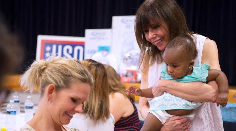 Heidi Murkoff, author of the best-selling ‘What to Expect’ book series, visits with Pernell Cofax, 1, and his mother, Carrielle, while she holds Makena Sprinkle, 7 months, during a baby shower at the Wright-Patterson Air Force Base USO Center Aug. 6. Makena is the daughter of LaDonna and Tech. Sgt. Rickey Sprinkle. Her father is attached to the National Air and Space Intelligence Center. (U.S. Air Force photo/R.J. Oriez)