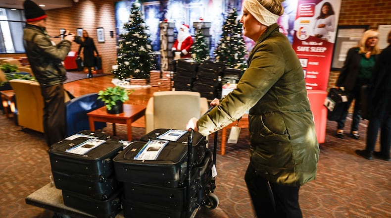 Montgomery County Children Services worker Kristin Sparks delivers suitcases from Omega Baptist Church, filled with personal care items for children entering foster care. Jim Noelker/Staff