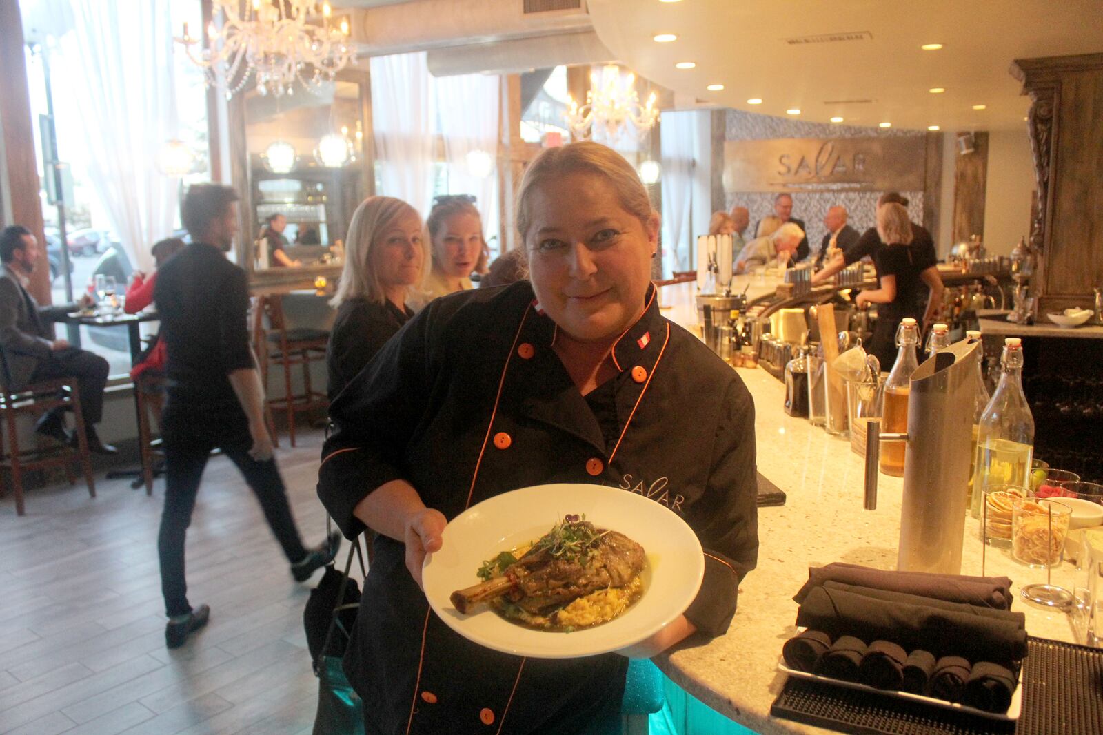 Salar Restaurant and Lounge  has been closed since a December fire. The restaurant in Dayton Oregon District is celebrating its reopening with event Sept 27 to 30, 2018. Chef/owner Margot Blondet holds a serving of Northern Peruvian style braised  lamb shank is pictured.
