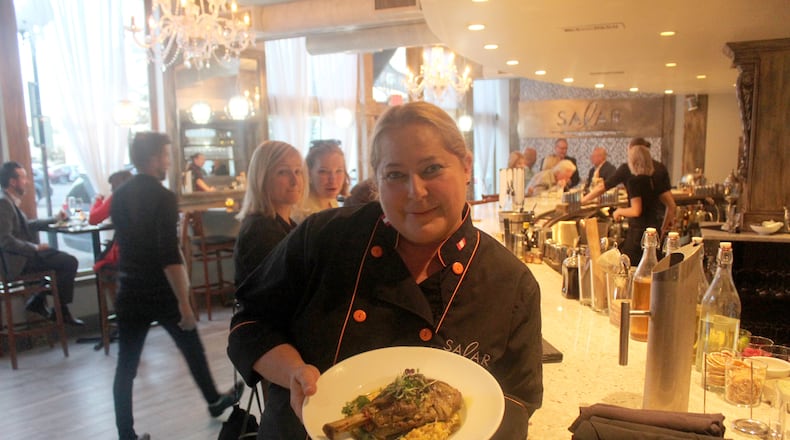 Salar Restaurant and Lounge has been closed since a December fire. The restaurant in Dayton Oregon District is celebrating its reopening with event Sept 27 to 30, 2018. Chef/owner Margot Blondet holds a serving of Northern Peruvian style braised lamb shank is pictured.