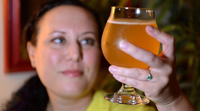 Jen Blair holds a glass of the finished grisette that she began brewing on June 17, 2017. She is a home brewer who just accepted a job in the beer industry as the executive director of the Craft Maltsters Guild of North America. (Jenna Eason/Charlotte Observer/TNS)