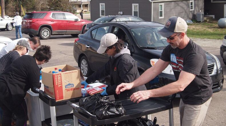 Feed the Creek volunteers help distribute food at a distribution event. CONTRIBUTED
