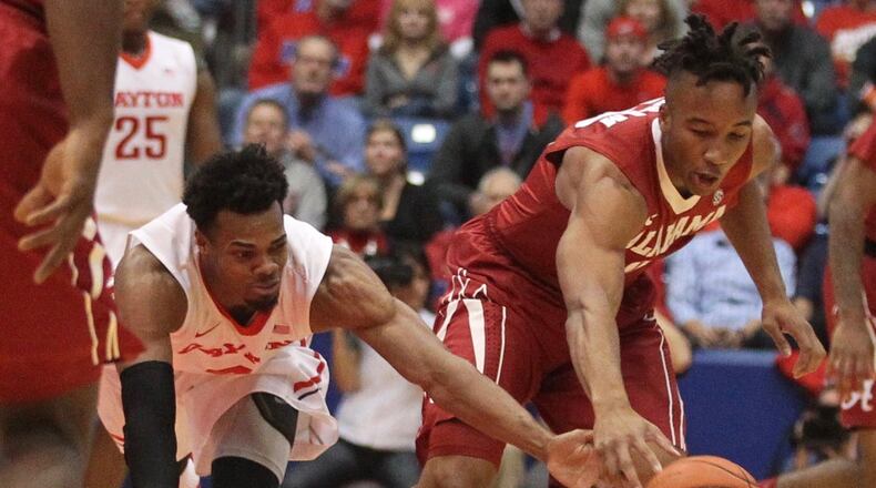 Dayton’s Charles Cooke, left, and Alabama’s Dazon Ingram chase a loose ball on Tuesday, Nov. 17, 2015, at UD Arena in Dayton. David Jablonski/Staff