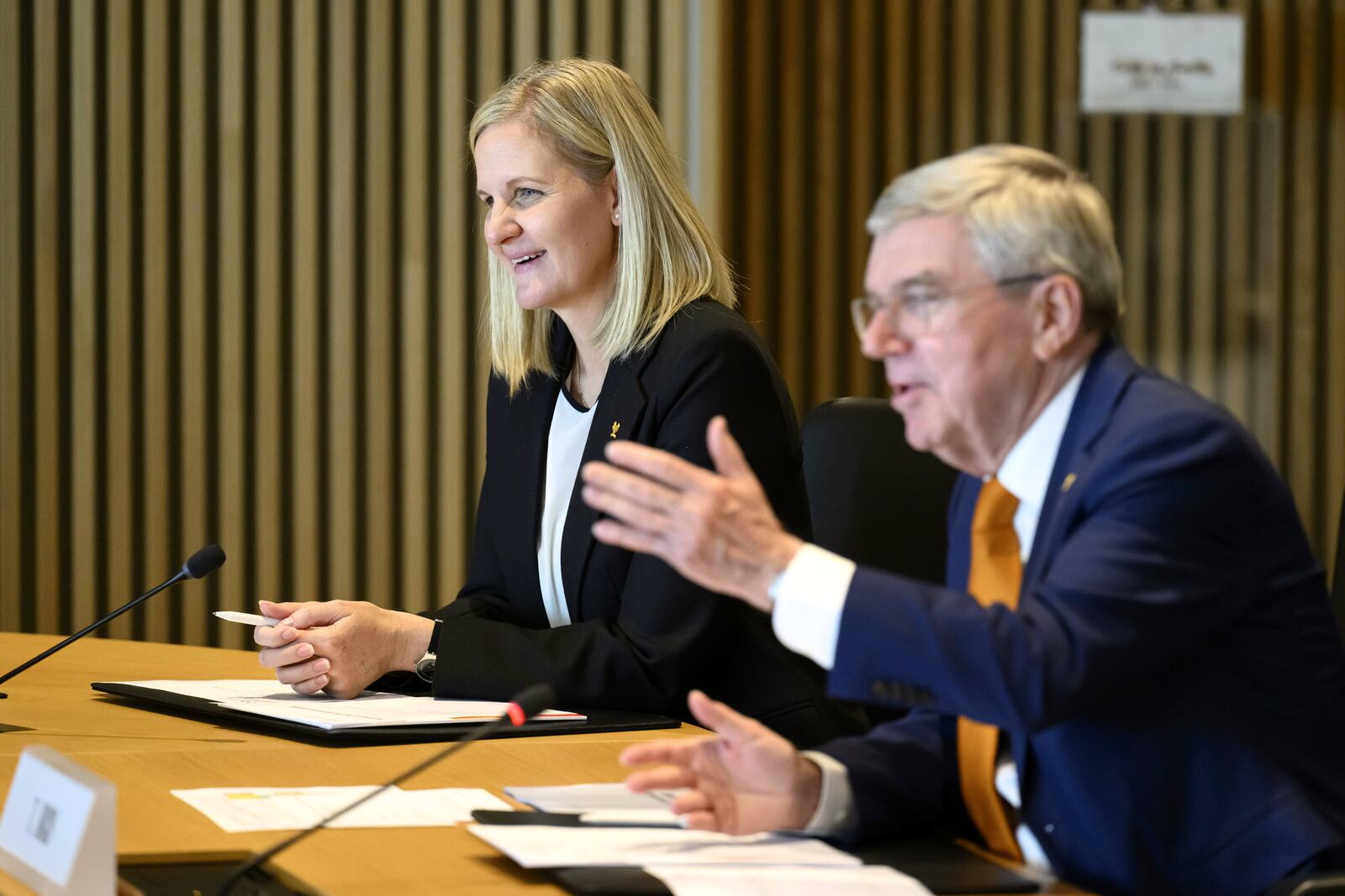 International Olympic Committee (IOC) President Thomas Bach, right, speaks next to the president-elect of the IOC Zimbabwean Kirsty Coventry, at the opening of the executive board meeting of the IOC, at the Olympic House, in Lausanne, Switzerland, Wednesday, April 9, 2025. (Laurent Gillieron/Keystone via AP)