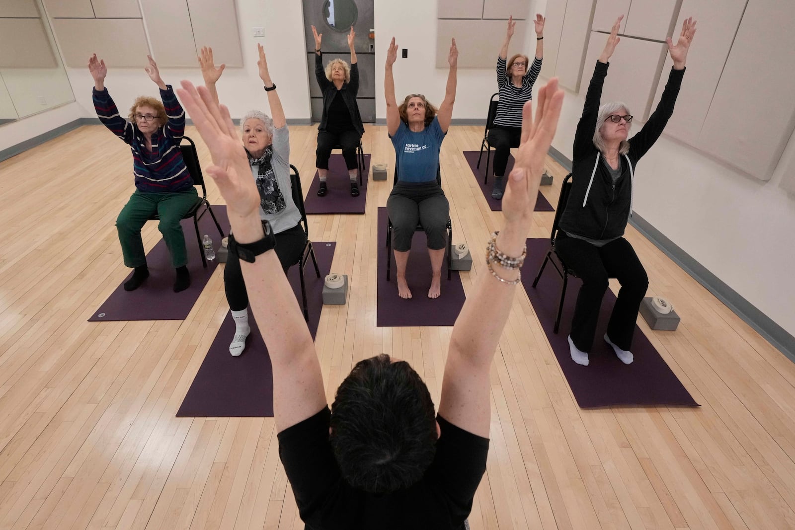 Whitney Chapman, foreground center, conducts a chair yoga class at the Marlene Meyerson JCC Manhattan, in New York, March 28, 2025. (AP Photo/Richard Drew)