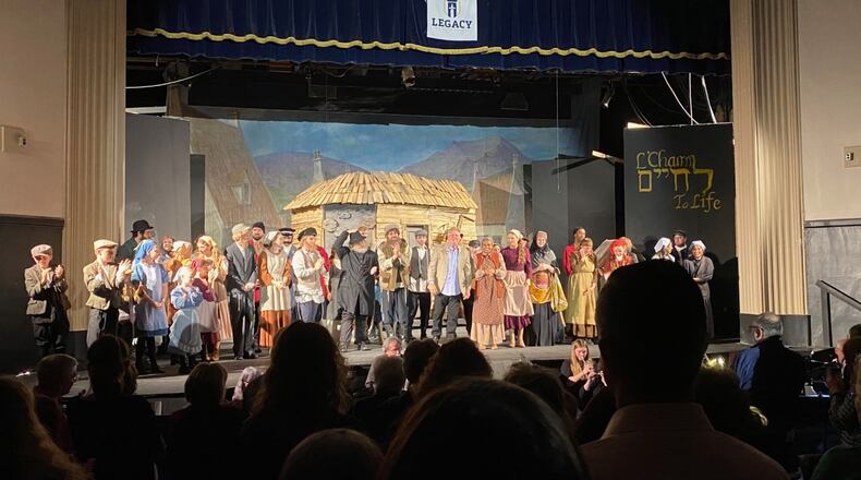 Ken Kettering with the cast on stage at Legacy Christian in Xenia for "Fiddler on the Roof" on April 22. CONTRIBUTED
