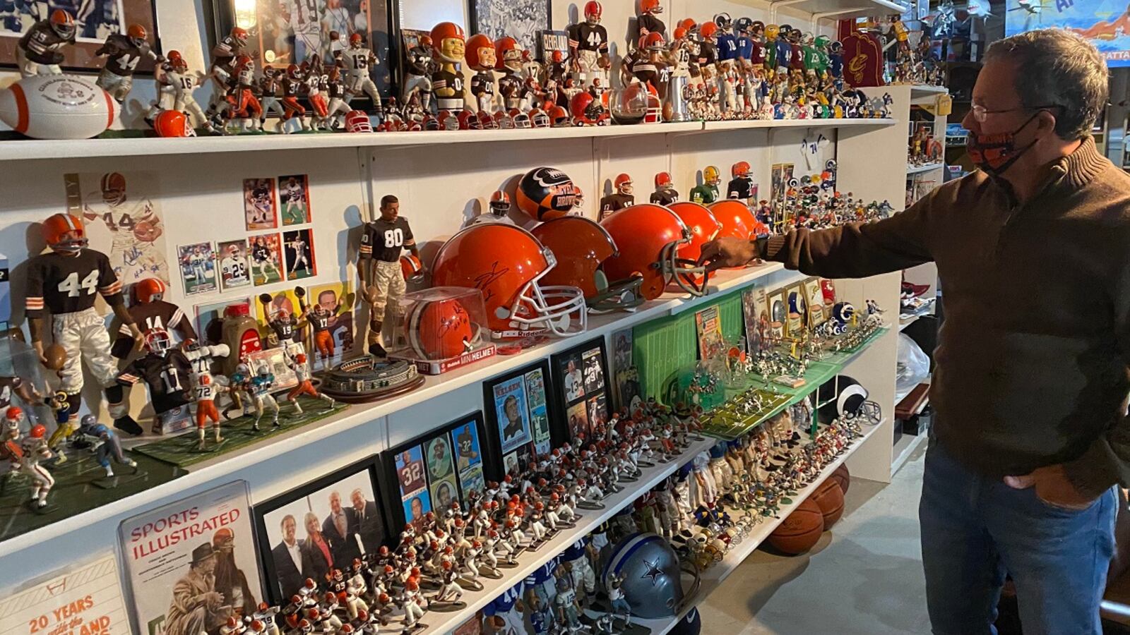 Charlie McMahan, senior pastor at Southbrook Christian Church in Miamisburg, has repurposed or enhanced thousands of items on display in the basement of his Centerville home, including this wall dedicated to the Cleveland Browns. PHOTOS BY STEVE MORRISON/CONTRIBUTED