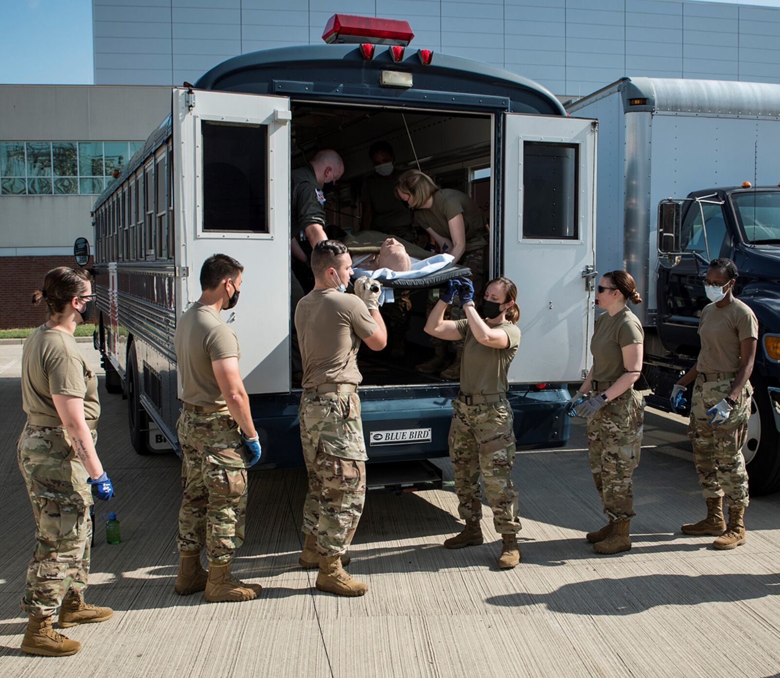 Medics from the 88th Medical Group unload a patient manikin from an ambulance bus during deployment training Aug. 12 provided by instructors from the U.S. Air Force School of Aerospace Medicine, part of the Air Force Research Laboratory’s 711th Human Performance Wing. U.S. AIR FORCE PHOTO/RICHARD ELDRIDGE