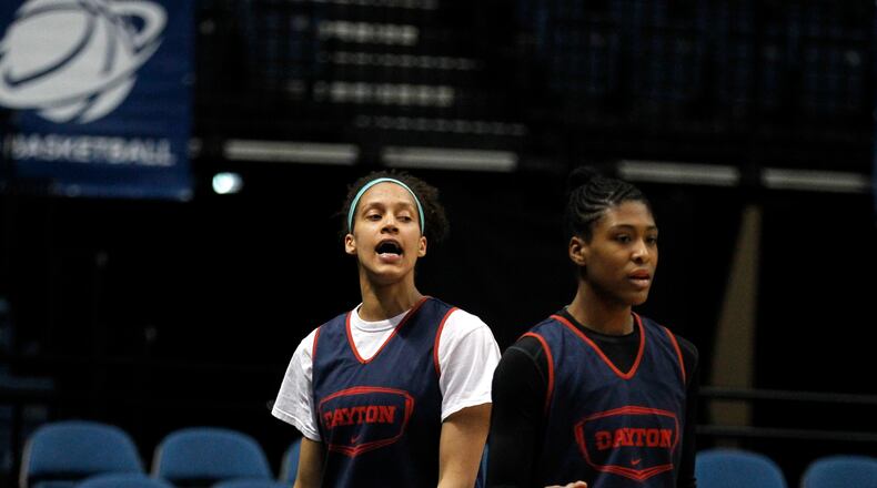 Dayton's Jodie Cornelie-Sigmundova, left, and Saicha Grant-Allen watch practice on Friday, March 27, 2015, at the Times Union Center in Albany, N.Y. David Jablonski/Staff