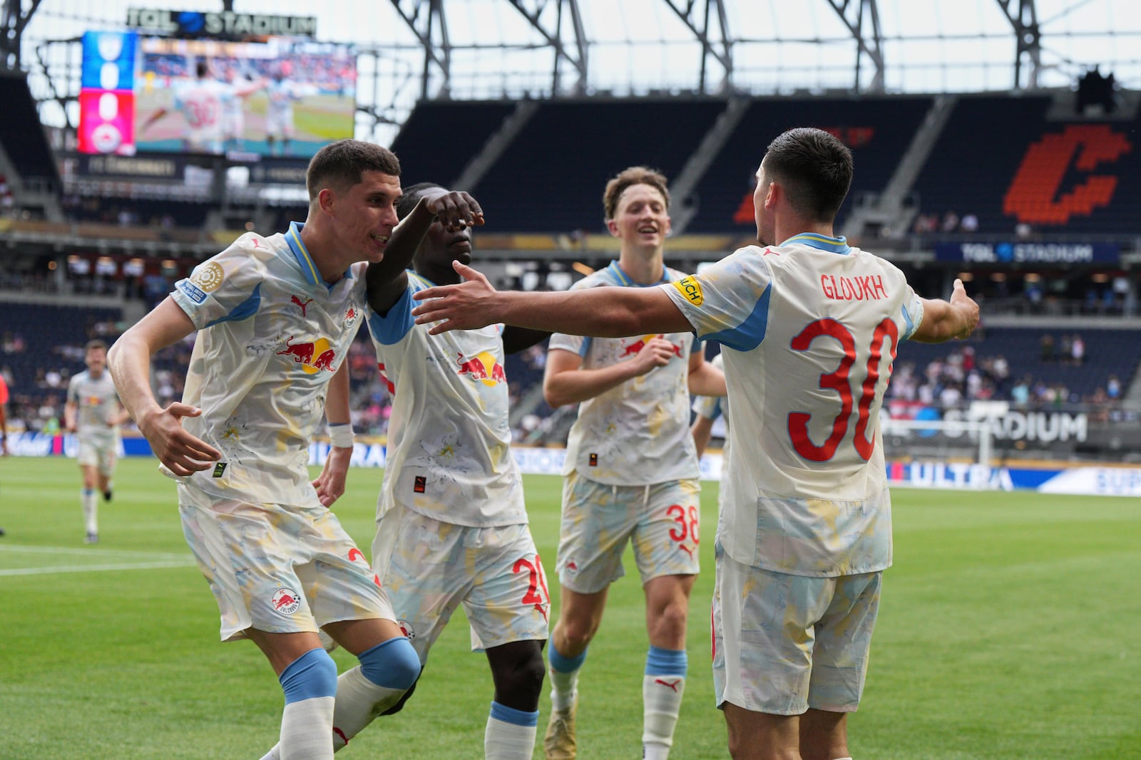 Red Bull Salzburg's Oscar Gloukh, right, celebrates with teammates after scoring his side's opening goal during the Club World Cup group H soccer match between CF Pachuca and FC Salzburg in Cincinnati, Wednesday, June 18, 2025. (AP Photo/Jeffrey Dean)