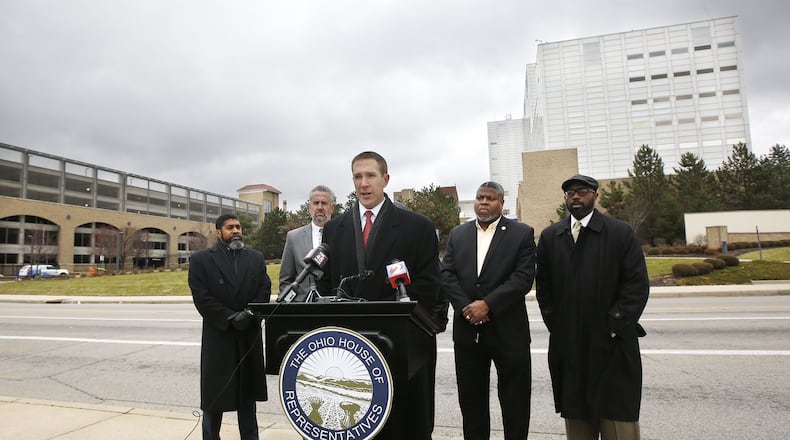 State Representatives Jim Butler (R-Oakwood) at podium, and Minority Leader Fred Strahorn (D-Dayton), left, held a press conference with other local civic leaders where they announced legislation to address the preservation of Good Samaritan Hospital and other hospital facilities for essential citizen access. TY GREENLEES / STAFF